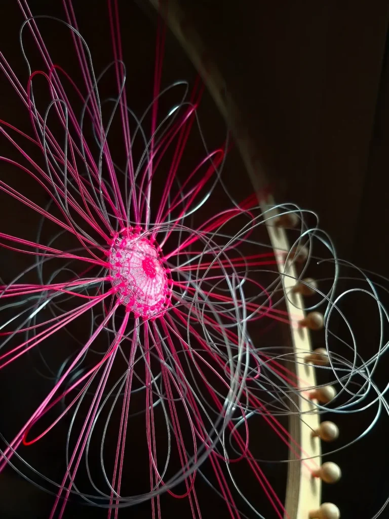 The beginnings of a floral weave on a circle loom by Lucy Sugden