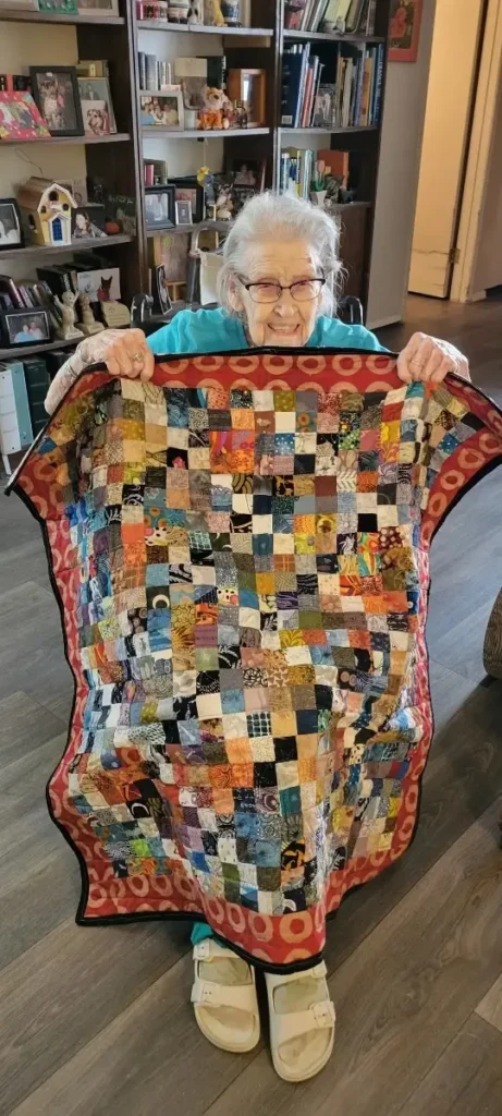 Grandma with a quilt made by Scot Augustston