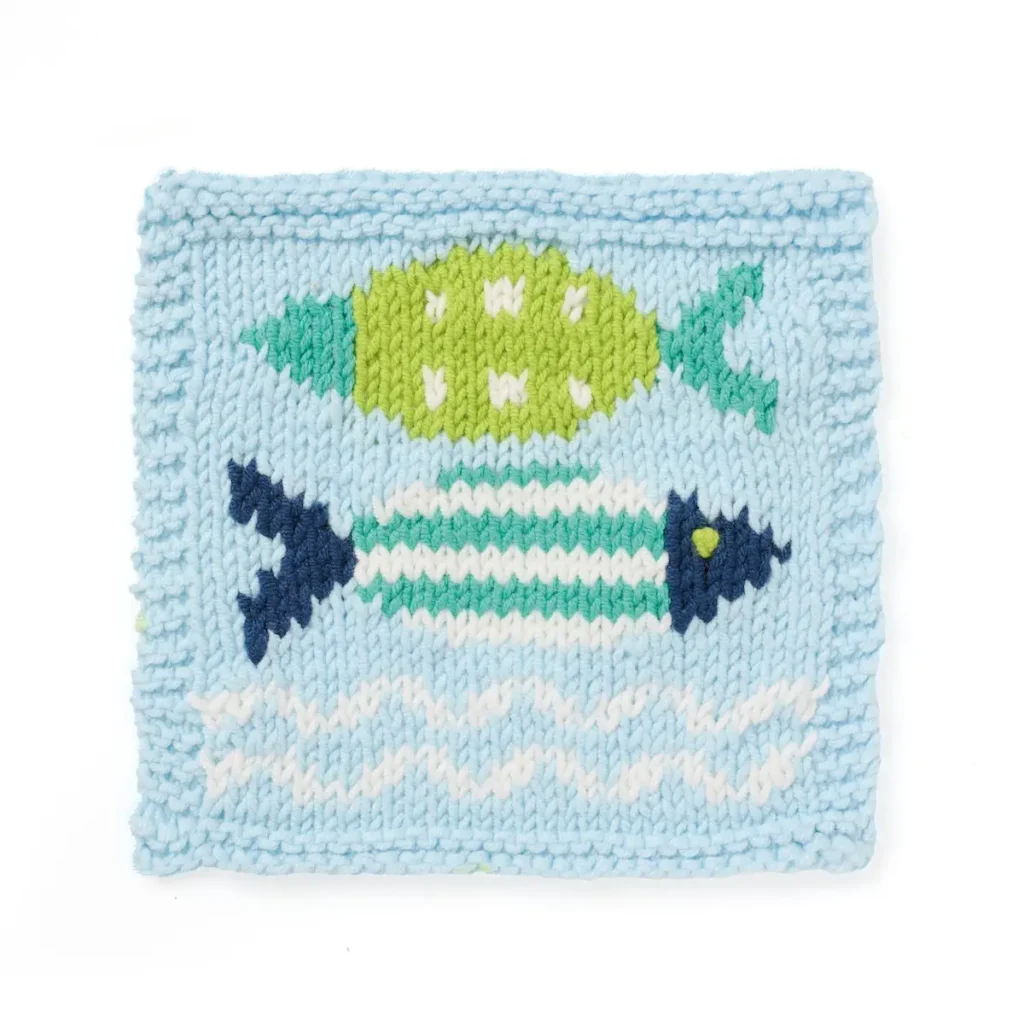 Fishes and waves knitting sampler by Sian Brown