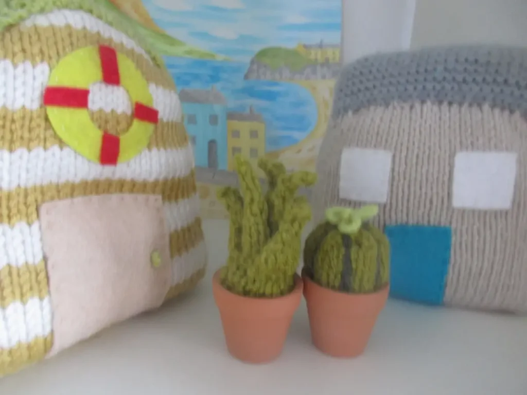 Knitted cactus with two knitted pillows by Sian Brown